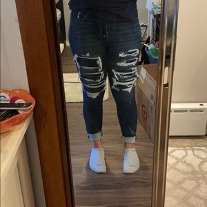 Dark colored patched jeans.